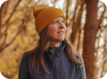 A woman looks hopeful in a hat.
