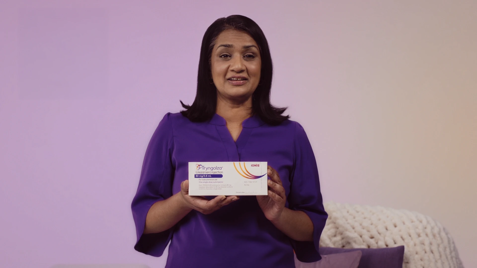 Woman holding TRYNGOLZA autoinjector box